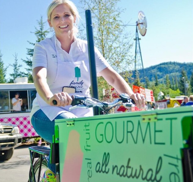 Custom branded green icecream bike at a popup food pod on a sunny day