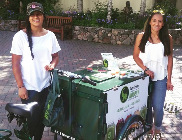 two smiling people with a green frame custom branded ice cream bike