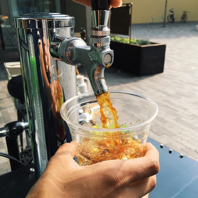 Cold brew coffee being poured from the tap straight from a bike / trike