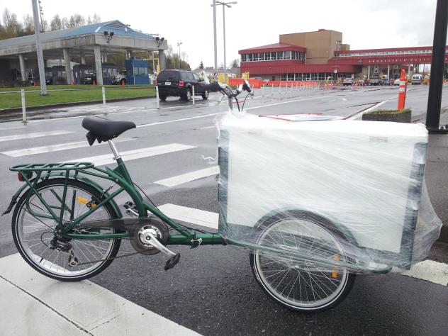 Icicle Tricycles Used Ice Cream Bike / trike partially packaged and parked at the curb by a ferry port in Washington