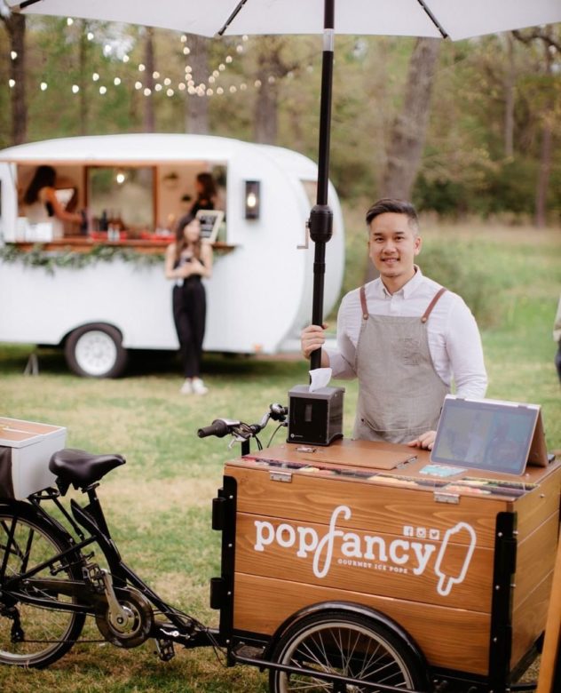 man posing with Popfancy cedar wood ice cream bike in front of a food cart