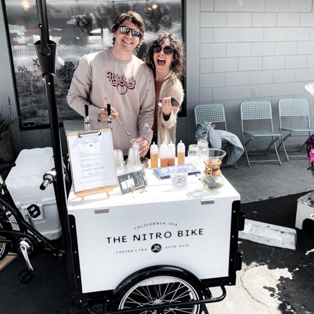 Alex & Erin Pujol catering cold brew on a sunny day from The Nitro Bike coffee bike